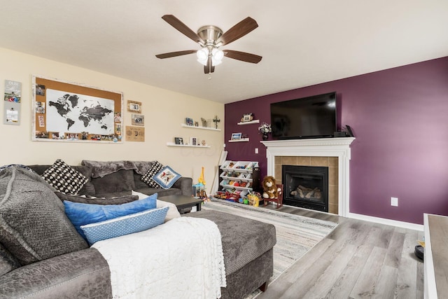 208 Dowler Dr, South Bloomfield, OH 43103 - living area featuring wood finished floors, ceiling fan, and a fireplace