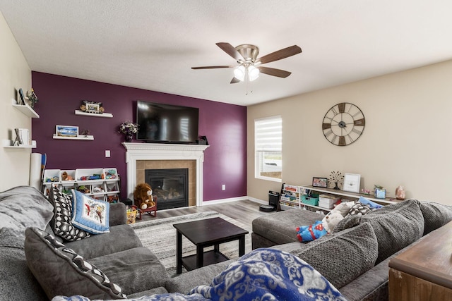 208 Dowler Dr, South Bloomfield, OH 43103 - living room featuring a ceiling fan, wood finished floors, and a tile fireplace