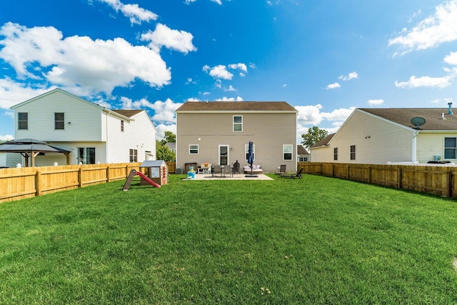 208 Dowler Dr, South Bloomfield, OH 43103 - rear view of house with a patio area, a fenced backyard, a gazebo, and a playground