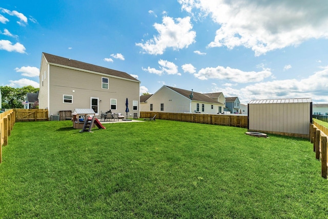 208 Dowler Dr, South Bloomfield, OH 43103 - rear view of property with a fire pit, a fenced backyard, and a patio