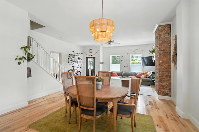 192 E Morrill Ave, Columbus, OH 43207 - dining area featuring a chandelier, light wood-style flooring, stairway, and ceiling fan