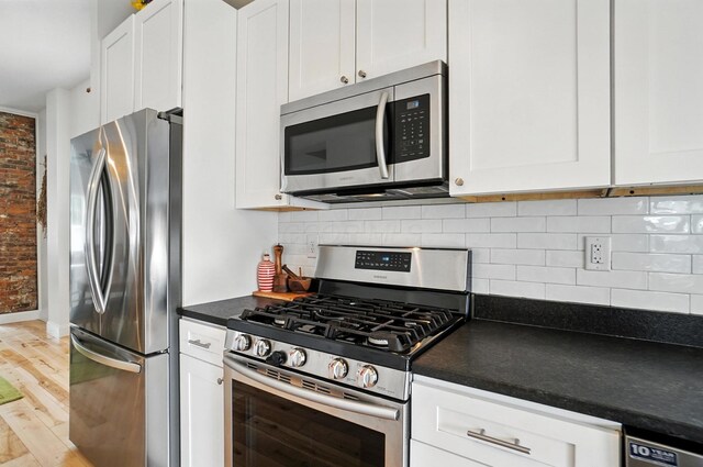 192 E Morrill Ave, Columbus, OH 43207 - kitchen with appliances with stainless steel finishes, dark countertops, and white cabinets