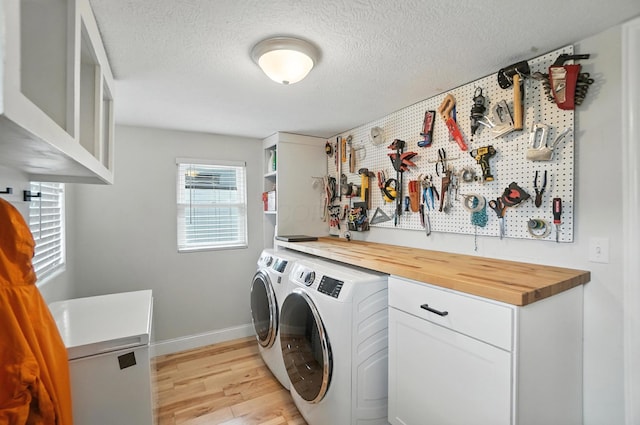 192 E Morrill Ave, Columbus, OH 43207 - washroom with separate washer and dryer, a workshop area, light wood-style floors, and a textured ceiling