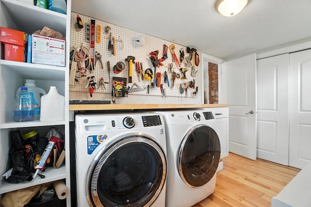 192 E Morrill Ave, Columbus, OH 43207 - washroom with washer and clothes dryer, wood finished floors, and a workshop area