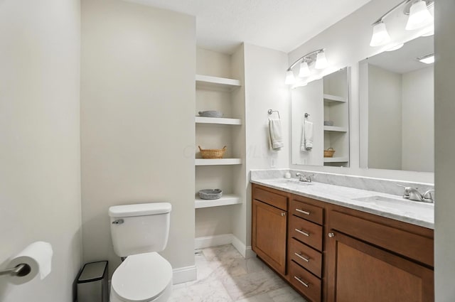 192 E Morrill Ave, Columbus, OH 43207 - full bathroom featuring marble look tiles, double vanity, and built in shelves