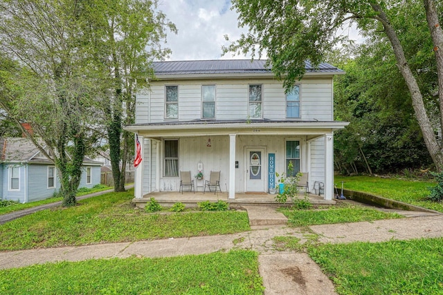 206 W Water St, New Lexington, OH 43764 - view of front of house featuring a porch, a metal roof, and a front yard