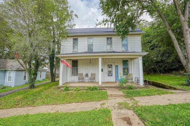 206 W Water St, New Lexington, OH 43764 - view of front of property with covered porch, a metal roof, and a front lawn
