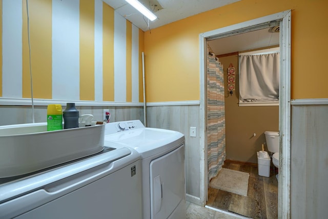 206 W Water St, New Lexington, OH 43764 - washroom with light wood-style floors, washing machine and clothes dryer, and a wainscoted wall