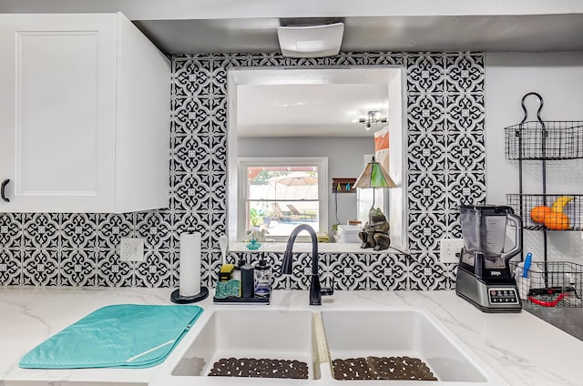 599 S Brinker Ave, Columbus, OH 43204 - kitchen featuring white cabinets, light stone counters, and tasteful backsplash