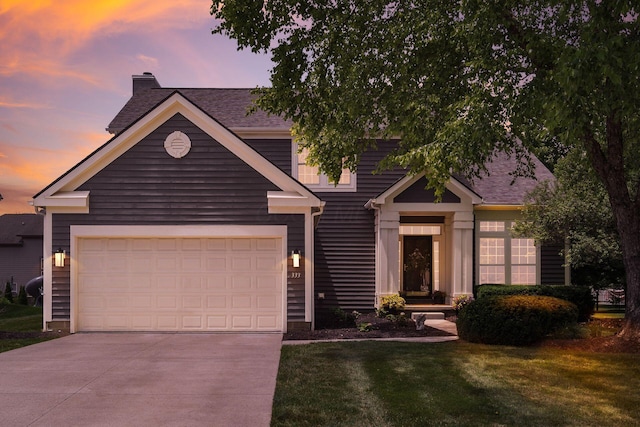 333 Quarter Way, Delaware, OH 43015 - view of front facade with a chimney, driveway, a lawn, a shingled roof, and a garage