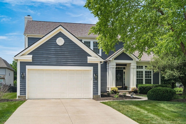 333 Quarter Way, Delaware, OH 43015 - view of front of property with concrete driveway, a front lawn, a shingled roof, and a chimney