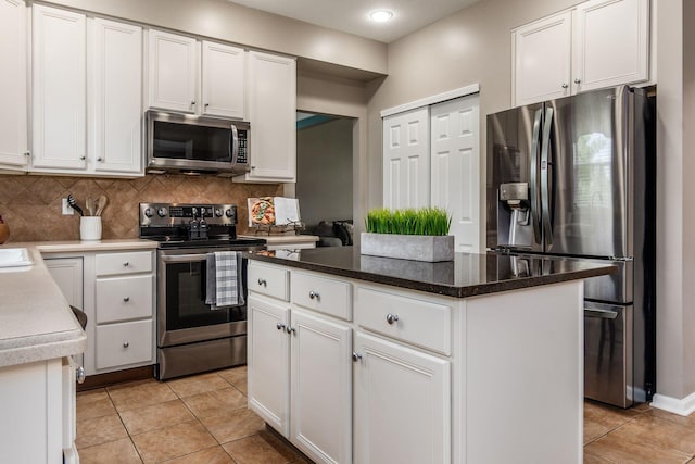 333 Quarter Way, Delaware, OH 43015 - kitchen with stainless steel appliances, light tile patterned flooring, backsplash, white cabinetry, and a center island