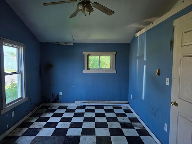 115 David St, Delaware, OH 43015 - spare room featuring plenty of natural light, a ceiling fan, baseboard heating, vaulted ceiling, and dark flooring