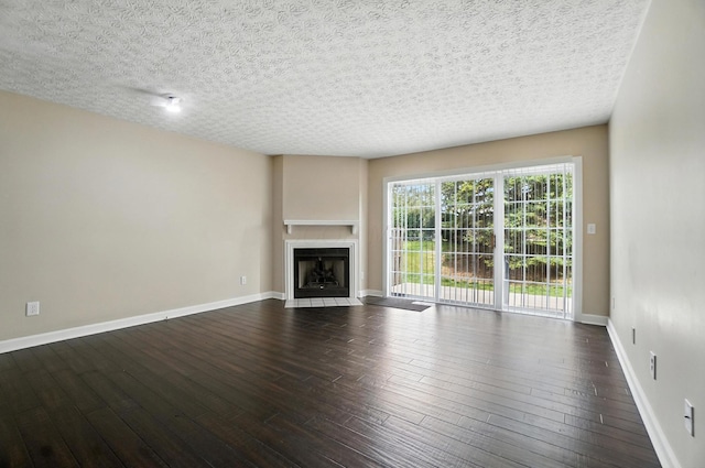 1812 Bennigan Dr Unit 88C, Hilliard, OH 43026 - unfurnished living room featuring dark wood-style floors, a fireplace with flush hearth, and a textured ceiling