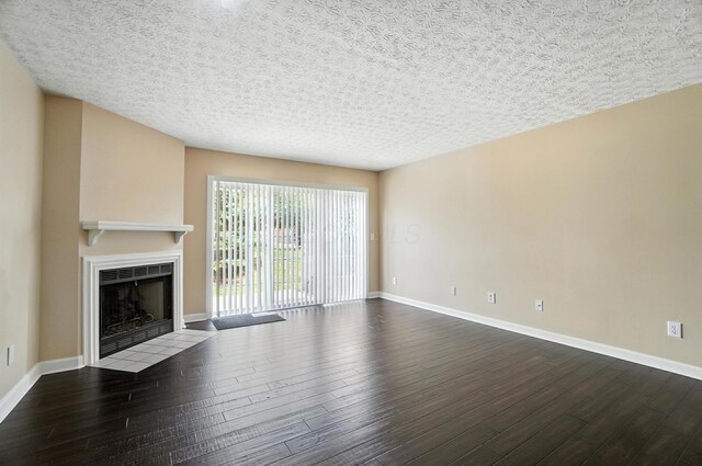 1812 Bennigan Dr Unit 88C, Hilliard, OH 43026 - unfurnished living room featuring a fireplace with flush hearth, wood finished floors, and a textured ceiling