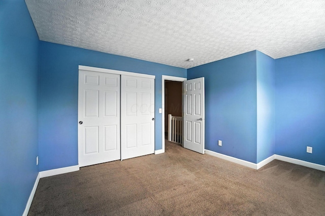 1812 Bennigan Dr Unit 88C, Hilliard, OH 43026 - unfurnished bedroom featuring carpet flooring, a closet, and a textured ceiling