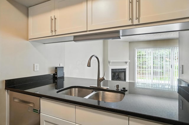 1812 Bennigan Dr Unit 88C, Hilliard, OH 43026 - kitchen with white cabinetry, dark countertops, and a fireplace