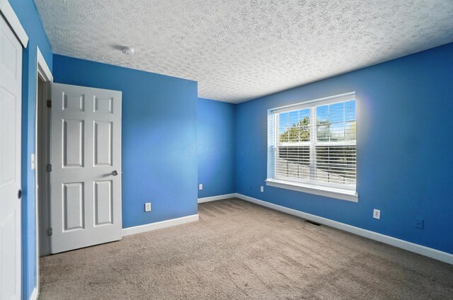 1812 Bennigan Dr Unit 88C, Hilliard, OH 43026 - unfurnished bedroom with carpet floors and a textured ceiling