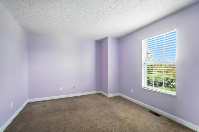 1812 Bennigan Dr Unit 88C, Hilliard, OH 43026 - carpeted empty room featuring baseboards and a textured ceiling