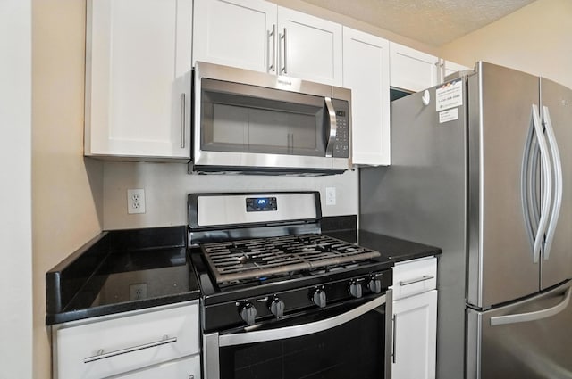 1812 Bennigan Dr Unit 88C, Hilliard, OH 43026 - kitchen with appliances with stainless steel finishes, white cabinetry, and dark stone counters