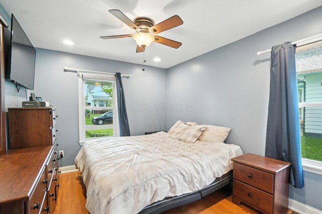 328 Maple Ave, Utica, OH 43080 - bedroom featuring light wood finished floors, multiple windows, a ceiling fan, and recessed lighting