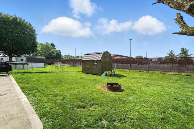 328 Maple Ave, Utica, OH 43080 - fenced backyard featuring a storage unit and a fire pit