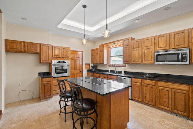 5373 Summit Rd SW, Pataskala, OH 43062 - kitchen with stainless steel appliances, brown cabinetry, a center island, dark countertops, and pendant lighting
