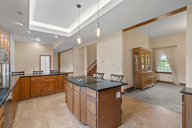 5373 Summit Rd SW, Pataskala, OH 43062 - kitchen with brown cabinets, black electric stovetop, a kitchen bar, a center island, and hanging light fixtures