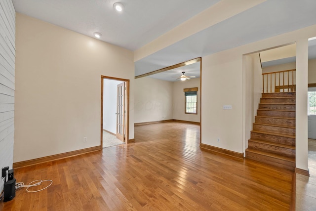 5373 Summit Rd SW, Pataskala, OH 43062 - unfurnished room with light wood finished floors, ceiling fan, and stairs