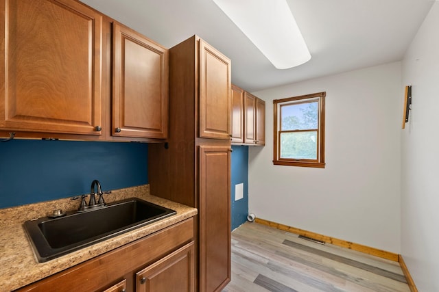 5373 Summit Rd SW, Pataskala, OH 43062 - kitchen featuring light wood-style flooring, light countertops, and brown cabinets