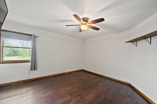 5373 Summit Rd SW, Pataskala, OH 43062 - unfurnished room with dark wood finished floors, a ceiling fan, and a textured ceiling