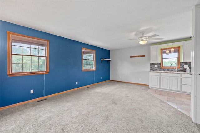 5373 Summit Rd SW, Pataskala, OH 43062 - unfurnished living room featuring light carpet, plenty of natural light, and ceiling fan