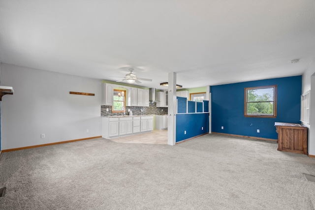 5373 Summit Rd SW, Pataskala, OH 43062 - unfurnished living room with light carpet, a ceiling fan, and plenty of natural light