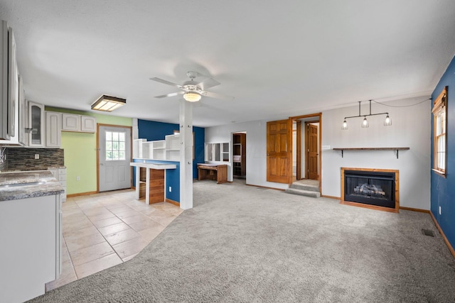 5373 Summit Rd SW, Pataskala, OH 43062 - unfurnished living room featuring a fireplace with flush hearth, a ceiling fan, light carpet, and light tile patterned floors