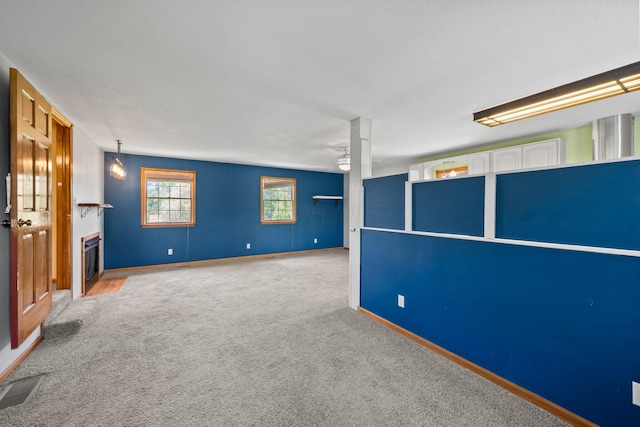 5373 Summit Rd SW, Pataskala, OH 43062 - carpeted empty room with a fireplace with flush hearth and a ceiling fan