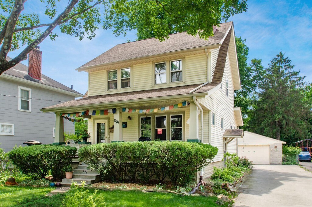 879 College Ave, Columbus, OH 43209 - view of front facade with a porch, an outbuilding, a shingled roof, and a garage