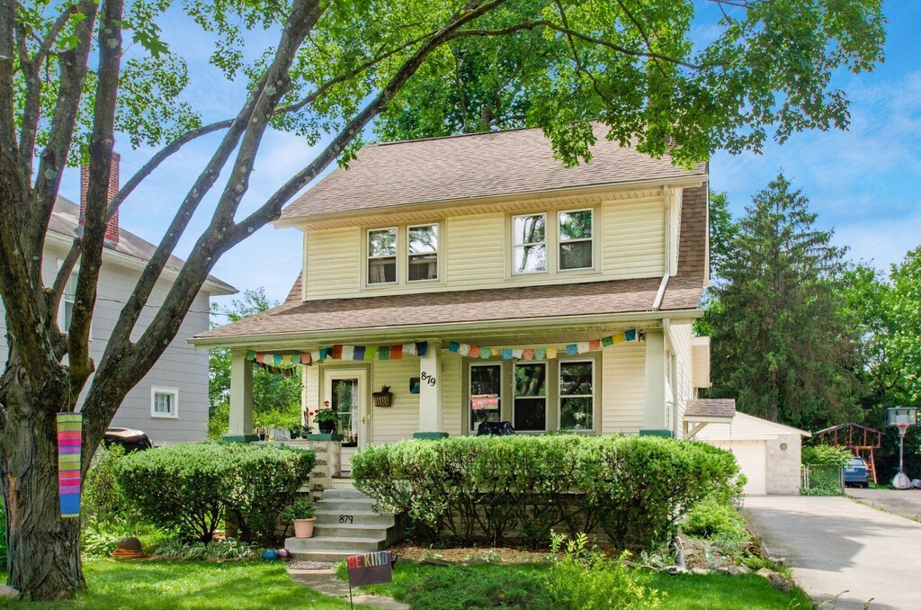 879 College Ave, Columbus, OH 43209 - view of front of house featuring covered porch, roof with shingles, and a garage