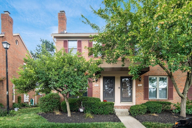 7911 Verandah Ct Unit 58, Powell, OH 43065 - view of front of property with brick siding, a chimney, and covered porch