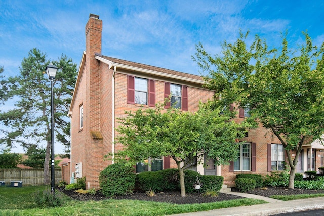 7911 Verandah Ct Unit 58, Powell, OH 43065 - view of front facade featuring brick siding and a chimney
