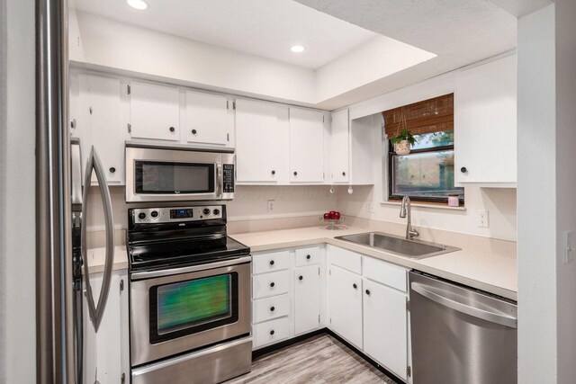 7911 Verandah Ct Unit 58, Powell, OH 43065 - kitchen featuring stainless steel appliances, light countertops, white cabinets, recessed lighting, and light wood-style floors