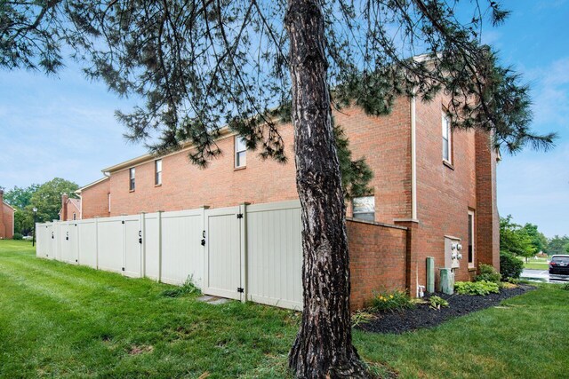 7911 Verandah Ct Unit 58, Powell, OH 43065 - view of side of property with brick siding and a gate