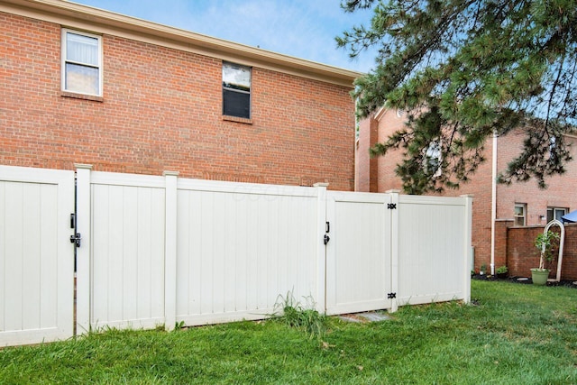 7911 Verandah Ct Unit 58, Powell, OH 43065 - view of home's exterior with a gate, a fenced backyard, and brick siding