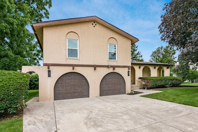 1571 Vinton Ave, Columbus, OH 43220 - mediterranean / spanish-style house featuring stucco siding, a garage, concrete driveway, and a front yard