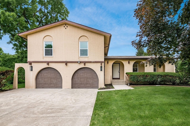 1571 Vinton Ave, Columbus, OH 43220 - mediterranean / spanish-style house with a garage, driveway, a front yard, and stucco siding