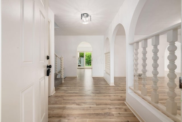 1571 Vinton Ave, Columbus, OH 43220 - entryway featuring light wood-type flooring, stairs, and arched walkways