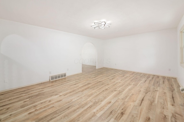 1571 Vinton Ave, Columbus, OH 43220 - empty room with wood finished floors and arched walkways