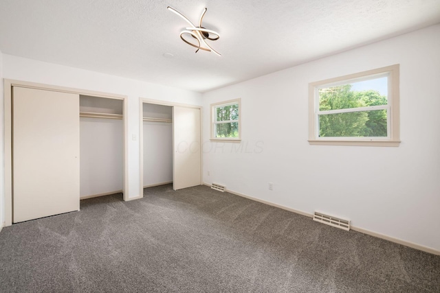 1571 Vinton Ave, Columbus, OH 43220 - unfurnished bedroom with two closets and carpet floors