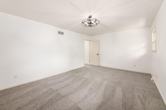 1571 Vinton Ave, Columbus, OH 43220 - carpeted empty room featuring a chandelier and baseboards