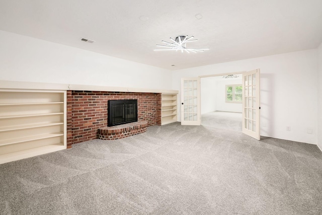 1571 Vinton Ave, Columbus, OH 43220 - unfurnished living room with french doors, carpet, and a brick fireplace