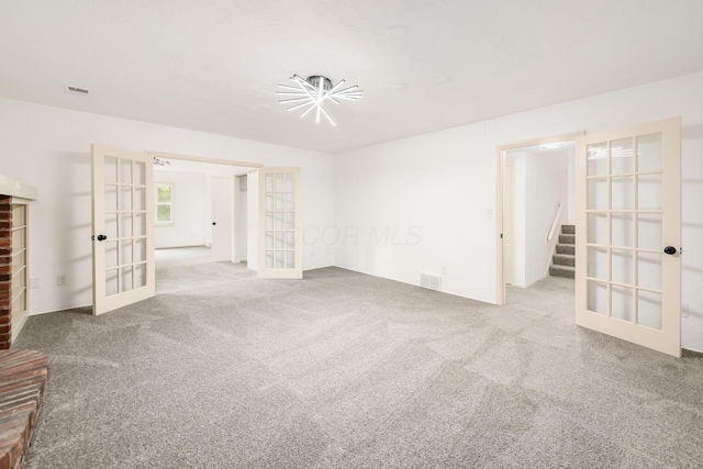 1571 Vinton Ave, Columbus, OH 43220 - empty room with french doors, carpet, and stairway